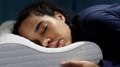 a close up of a person sleeping on a pillow