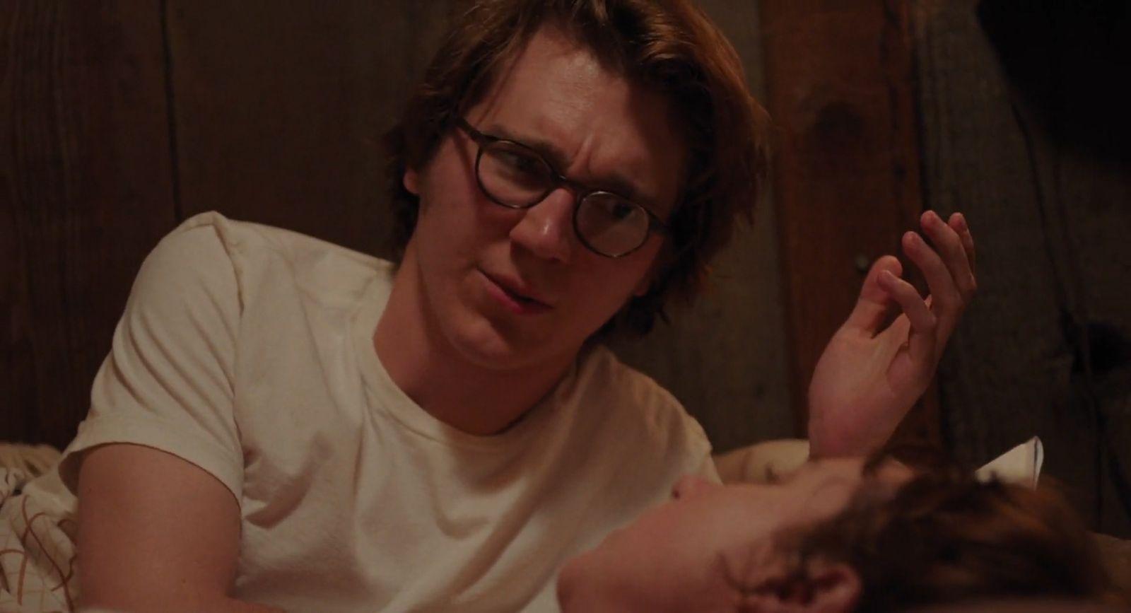 a man laying in bed next to a woman