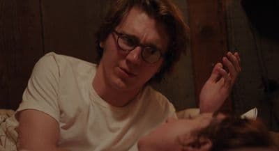 a man laying in bed next to a woman