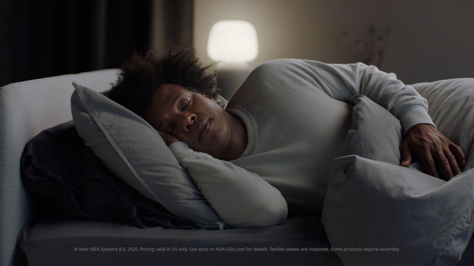 a man sleeping on a couch with a pillow