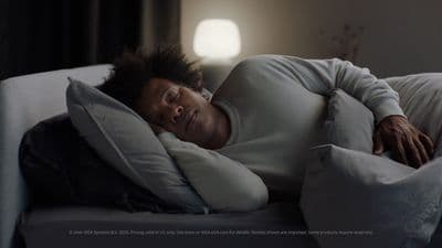 a man sleeping on a couch with a pillow