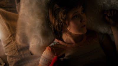 a woman laying on top of a bed covered in fur