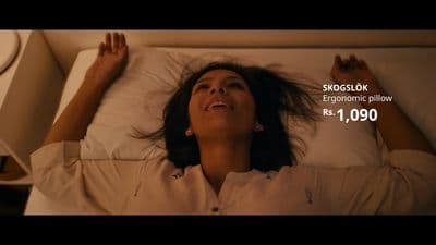 a woman laying in a bed with a pillow