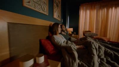 a man and a woman laying on a bed