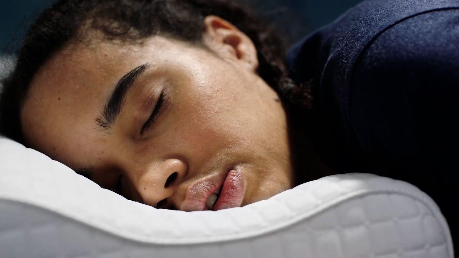 a close up of a person sleeping on a pillow