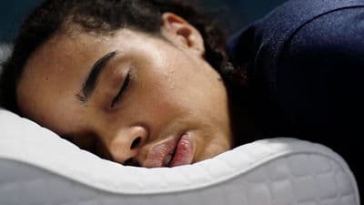 a close up of a person sleeping on a pillow