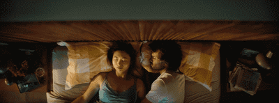 a man and a woman laying in a bed
