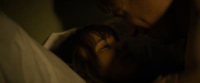 a man and a woman laying in bed together