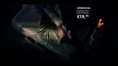 a person laying on a bed in a dark room