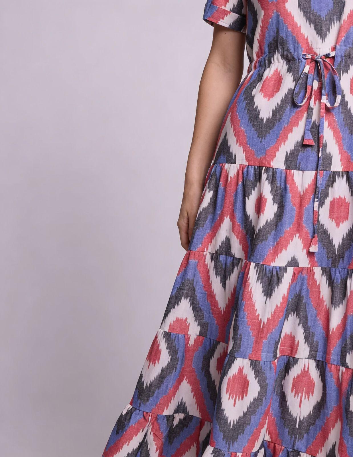 a woman wearing a dress with a red, white and blue pattern