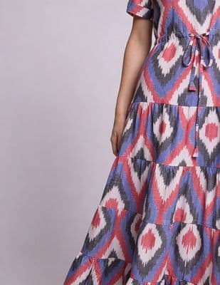 a woman wearing a dress with a red, white and blue pattern