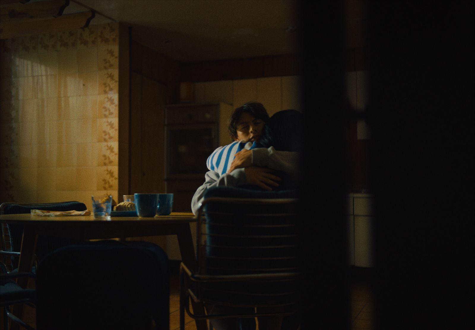 a man sitting at a table in a dark room