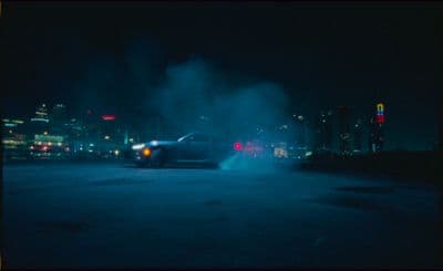 a car driving down a street at night