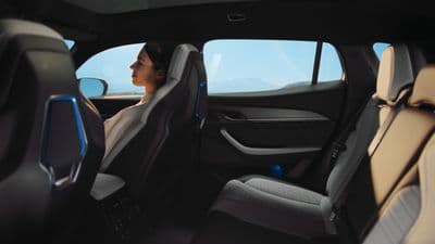 a woman sitting in the passenger seat of a car