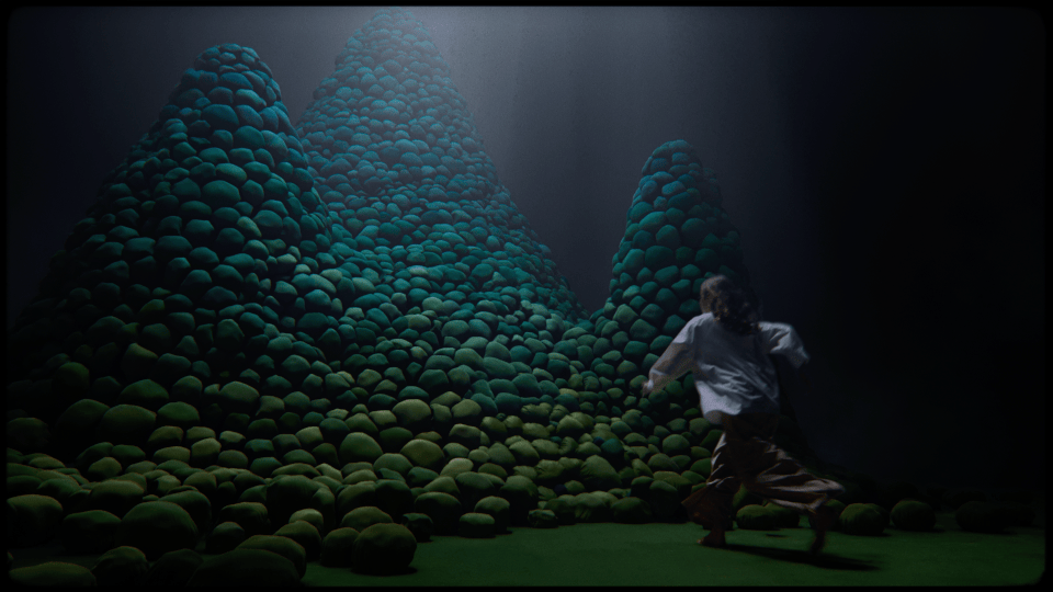 a man is running in front of a painting