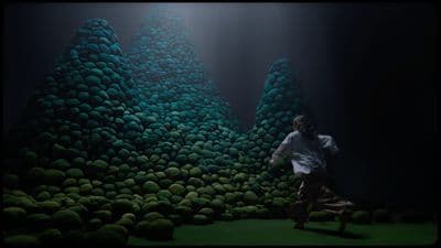 a man is running in front of a painting
