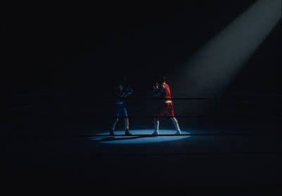 a couple of people that are standing in the dark