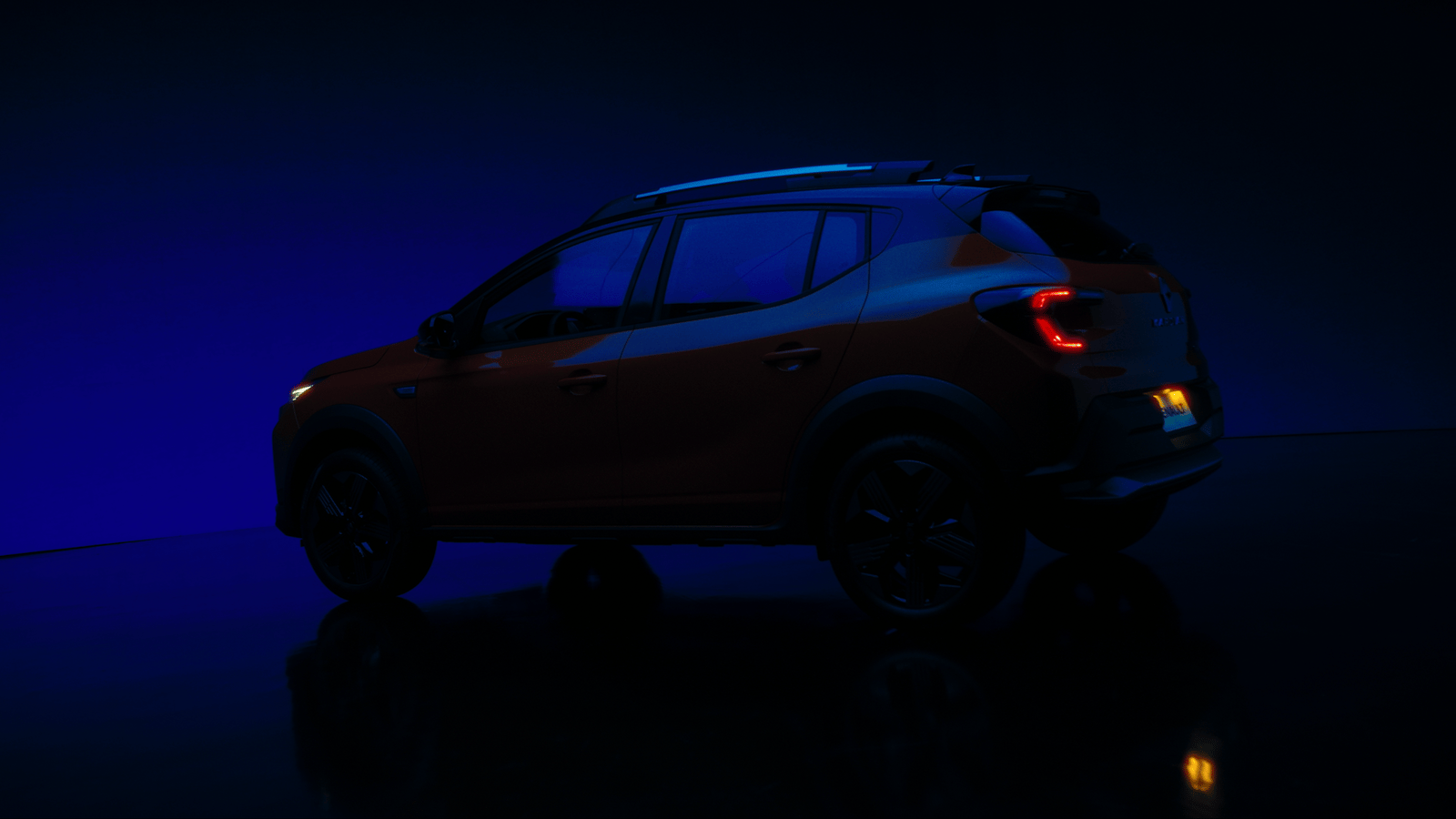a red car parked in a dark room
