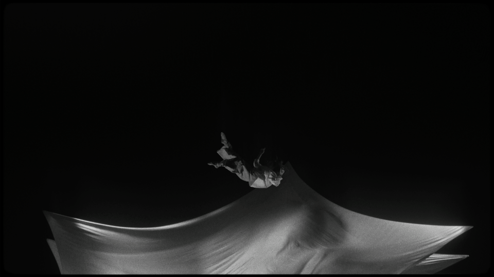 a person flying through the air while riding a snowboard