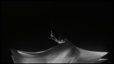 a person flying through the air while riding a snowboard