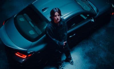 a man standing next to a car in the dark