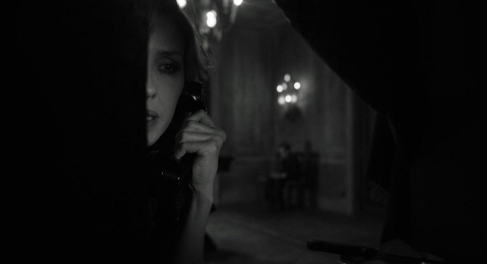 a woman talking on a cell phone in a dark room