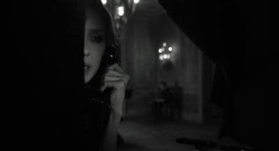 a woman talking on a cell phone in a dark room