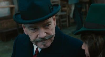 a man with a mustache and a green hat