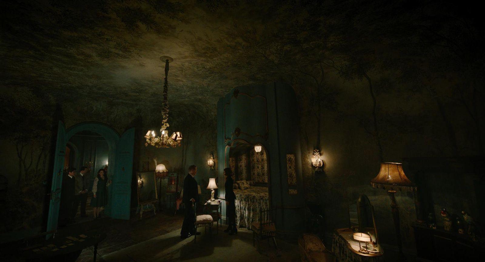 a dark room with a chandelier and a chandelier hanging from the