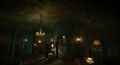 a dark room with a chandelier and a chandelier hanging from the