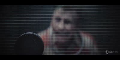 a blurry image of a woman's face behind blinds