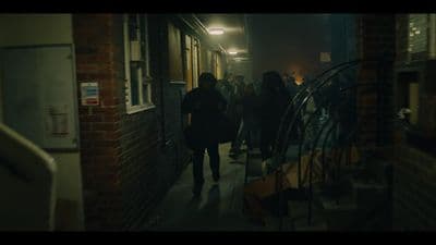 a group of people walking down a hallway