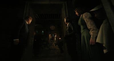 a group of people standing in a dark hallway