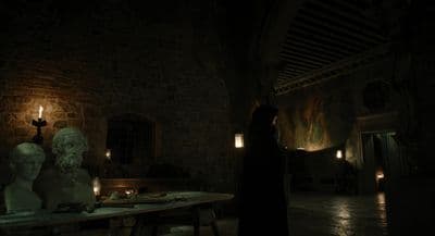 a person standing in a dark room next to a table