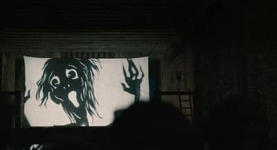 a person standing in front of a large screen