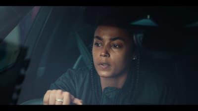 a woman with braids sitting in a car