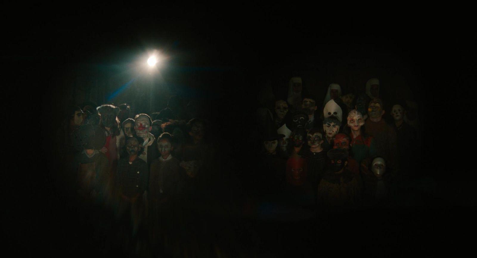a crowd of people standing around a street light