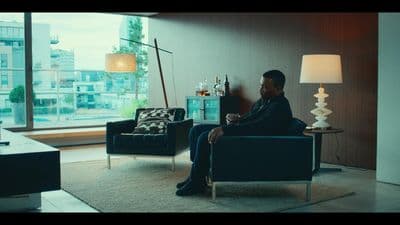 a man sitting in a chair in a living room