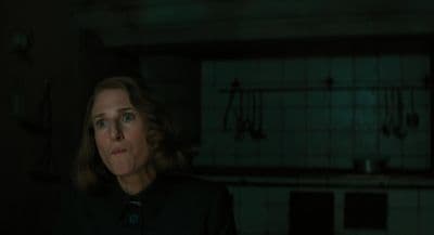 a woman standing in a dark room in the dark