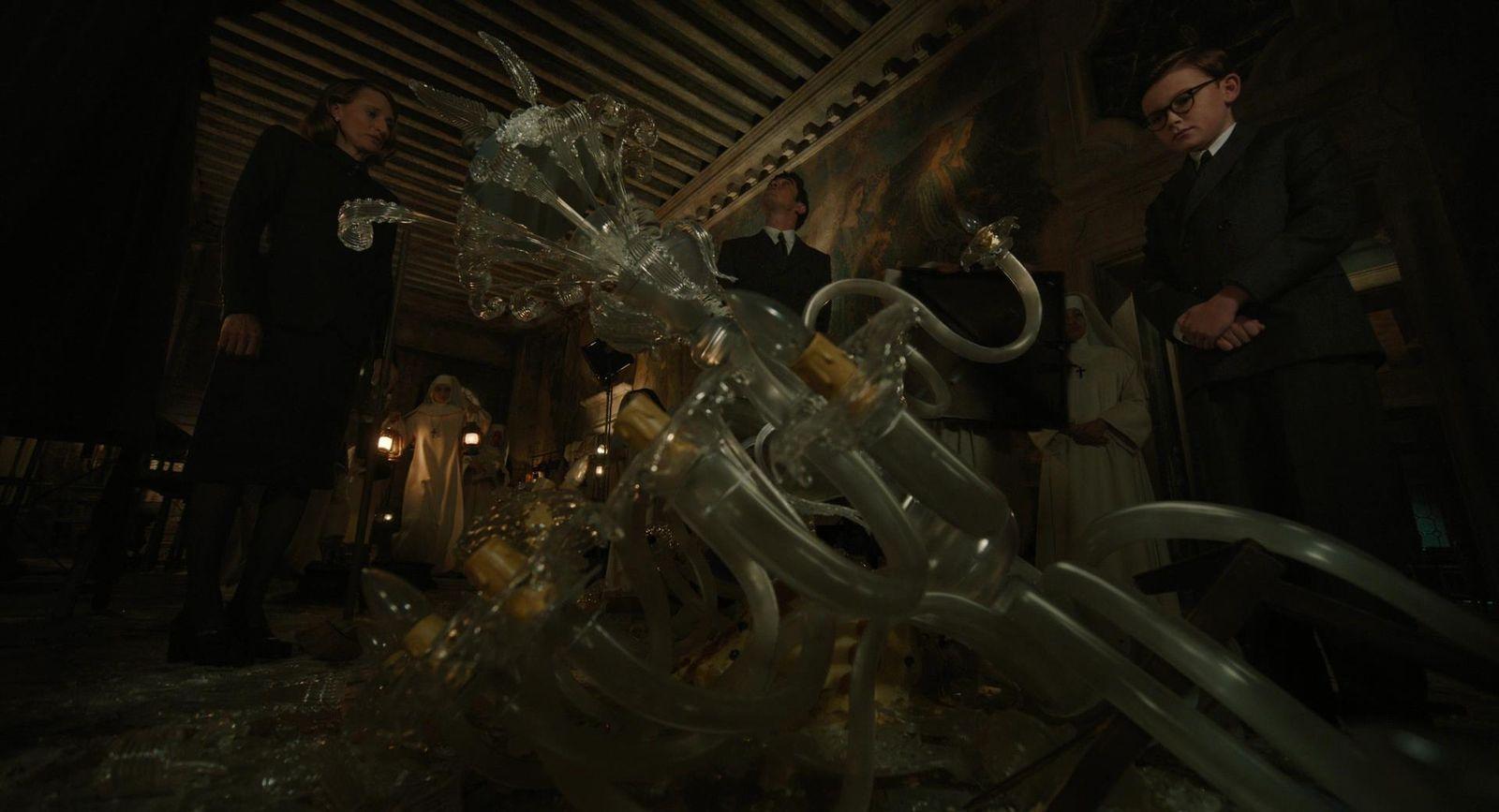 a group of people standing around a glass sculpture