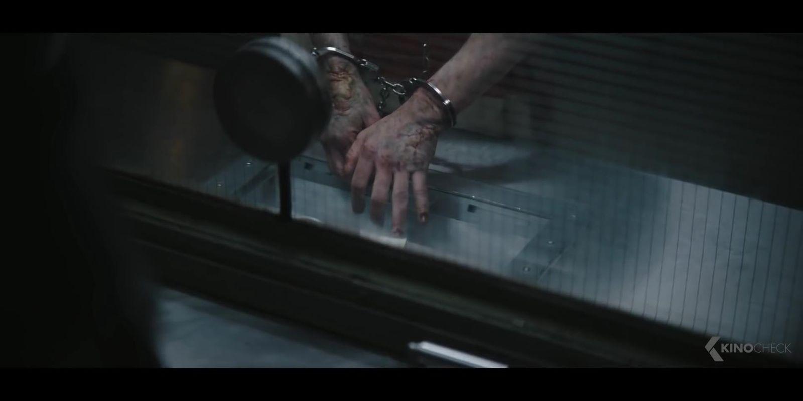 a person with tattoos on their hands reaching for something