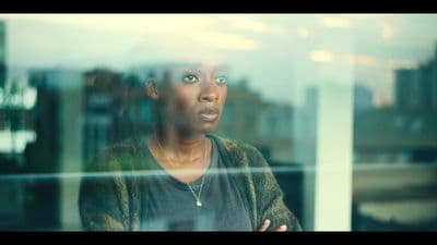 a woman standing in front of a window