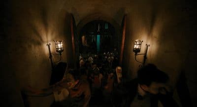 a group of people walking down a dark hallway