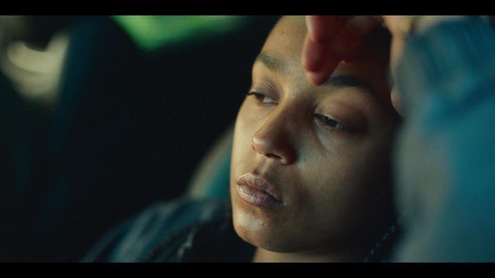 a woman sitting in a car getting her hair combed