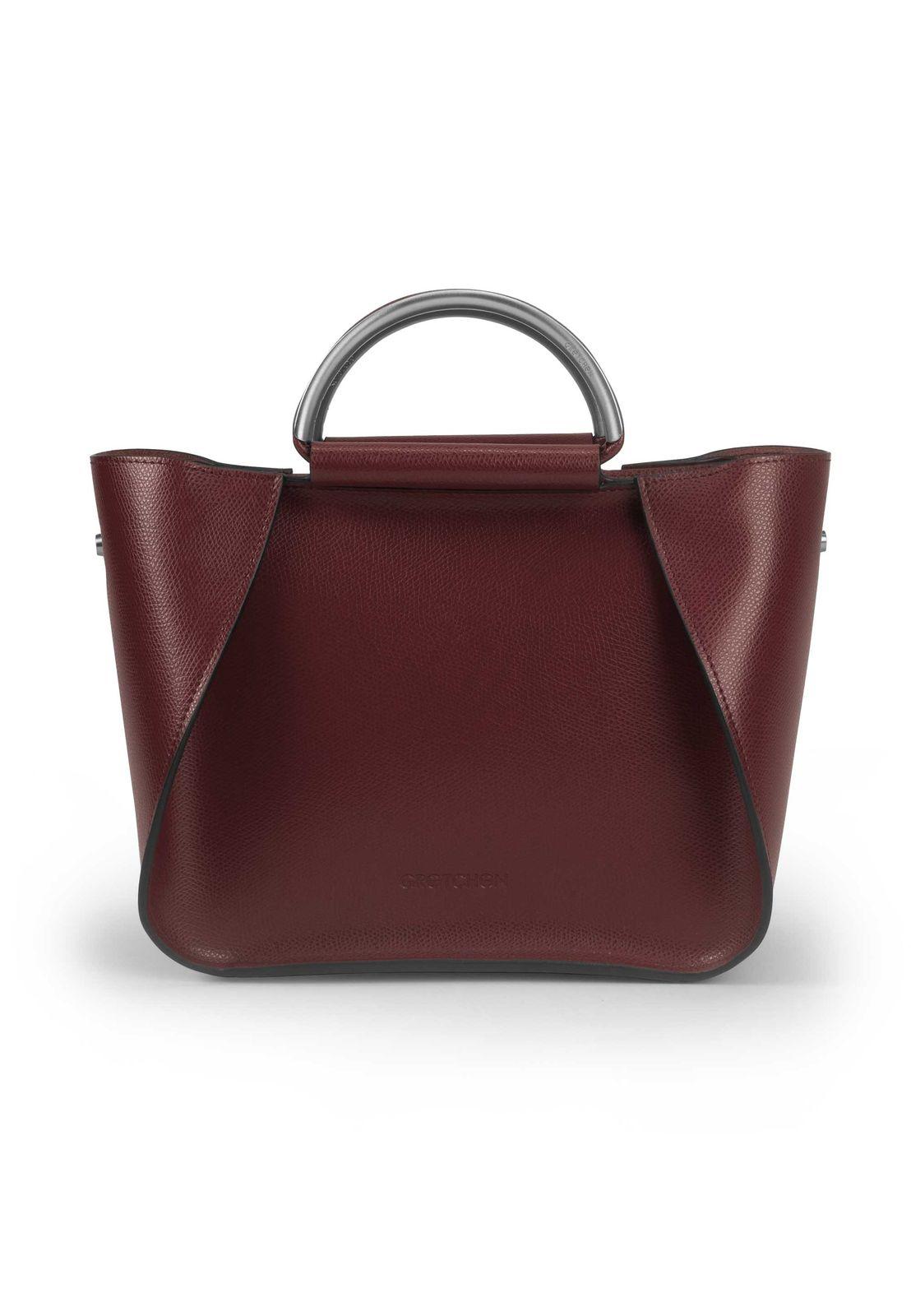a red handbag with a metal handle