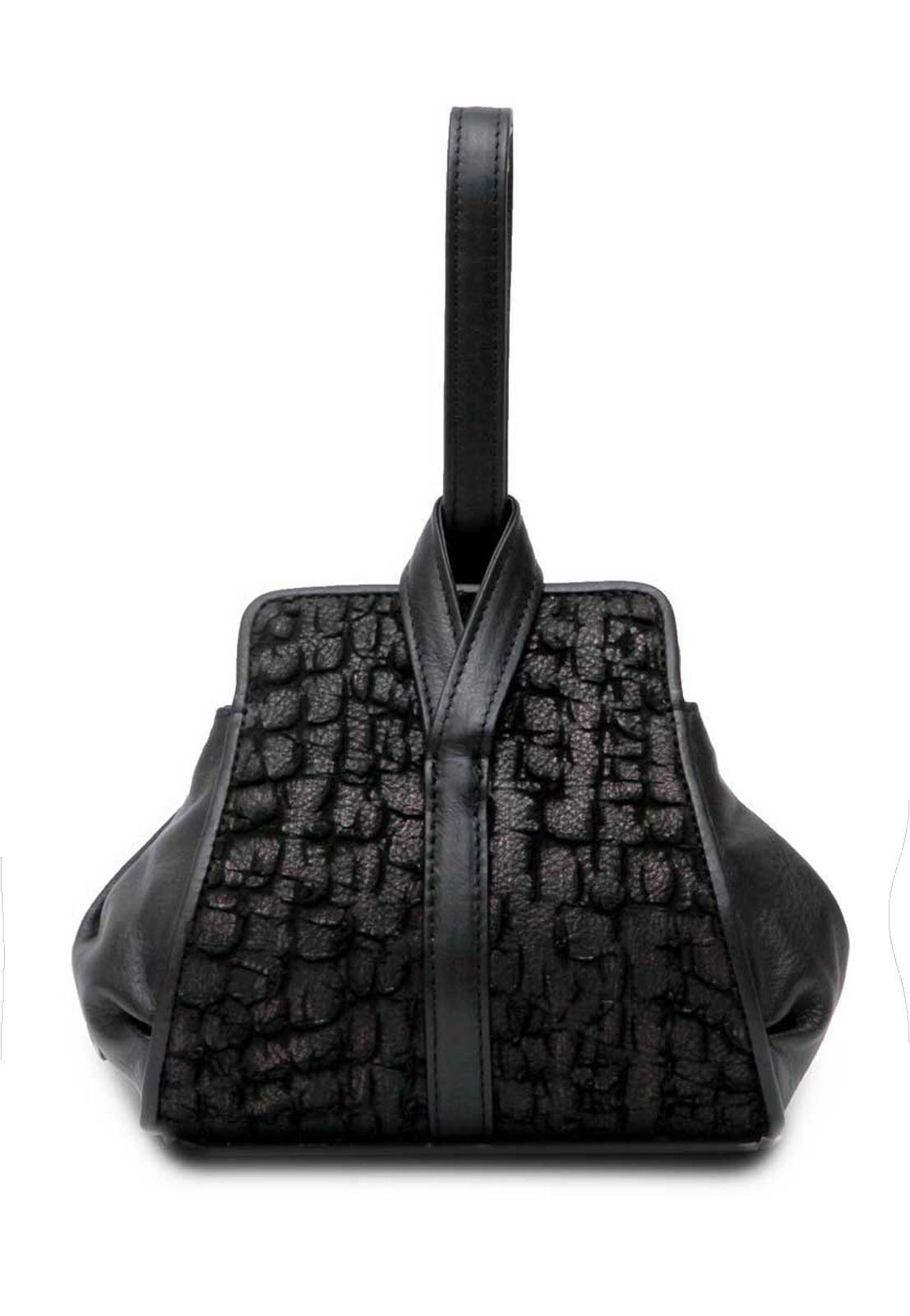 a black purse sitting on top of a white surface
