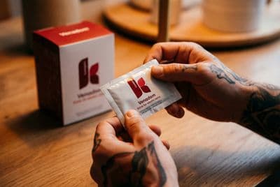 a man is holding a packet of kleenex