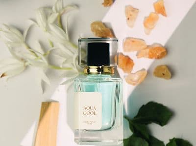 a bottle of perfume sitting on top of a table