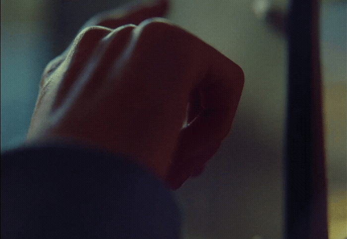 a person's hand reaching for something in a mirror