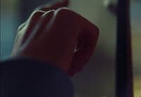 a person's hand reaching for something in a mirror